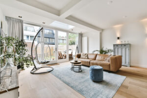A lovely living room with a brown sofa and white ones with hanging swings